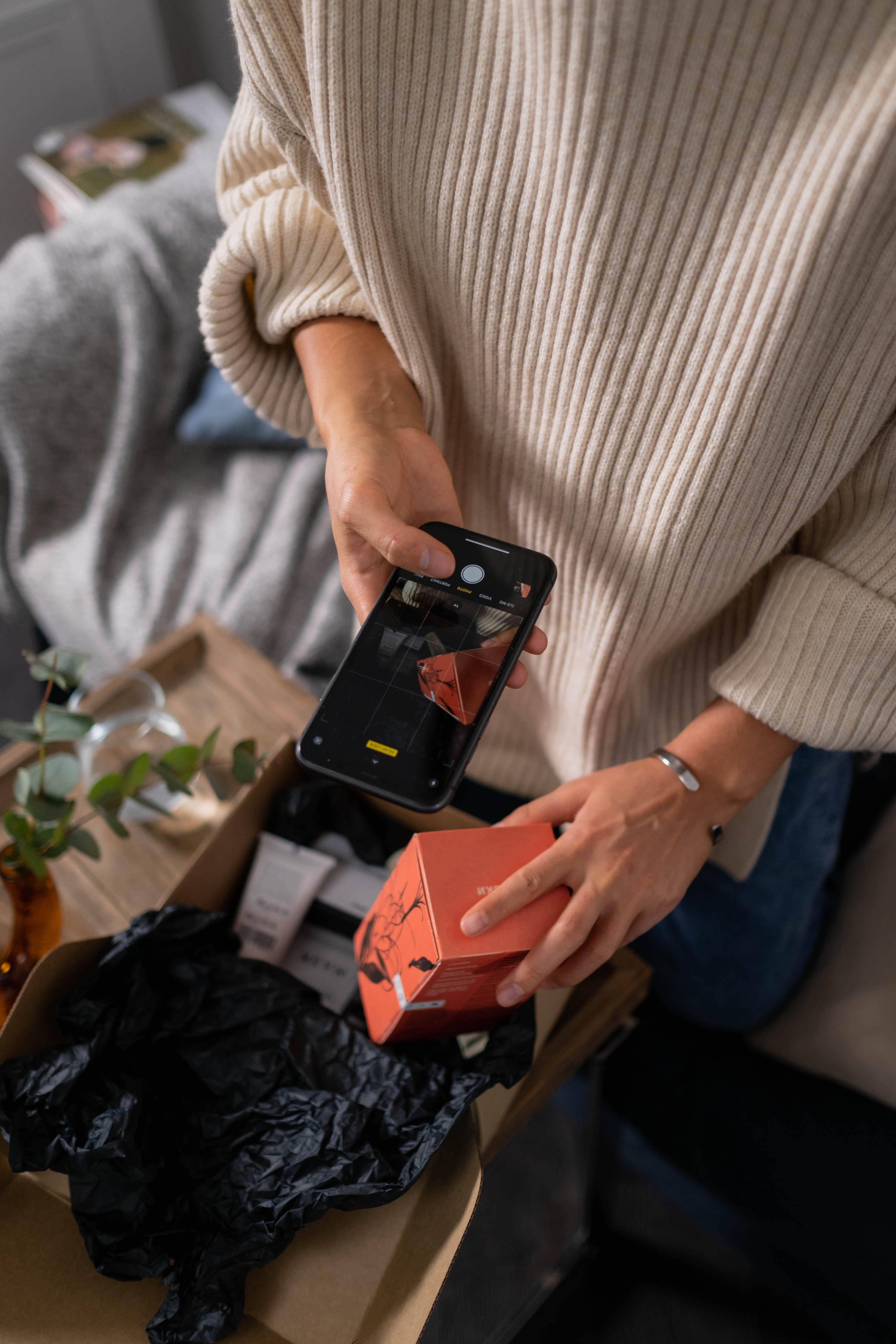 A vendor photographing a product with their phone to list it for sale
