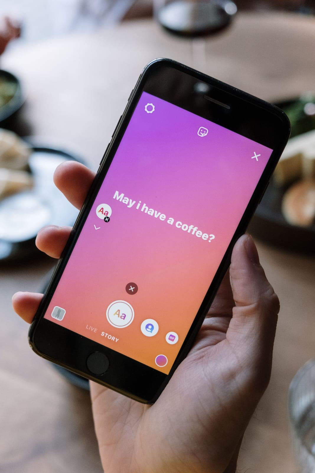 A phone showing a social feed being scrolled